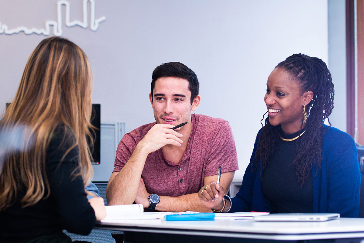 Two students discussing the program with an advisor