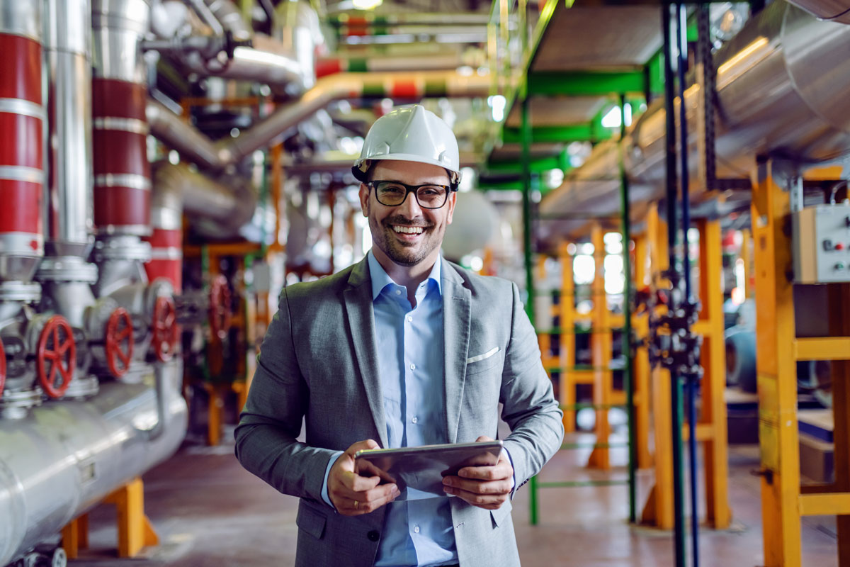 Man with tablet computer inside a power plant