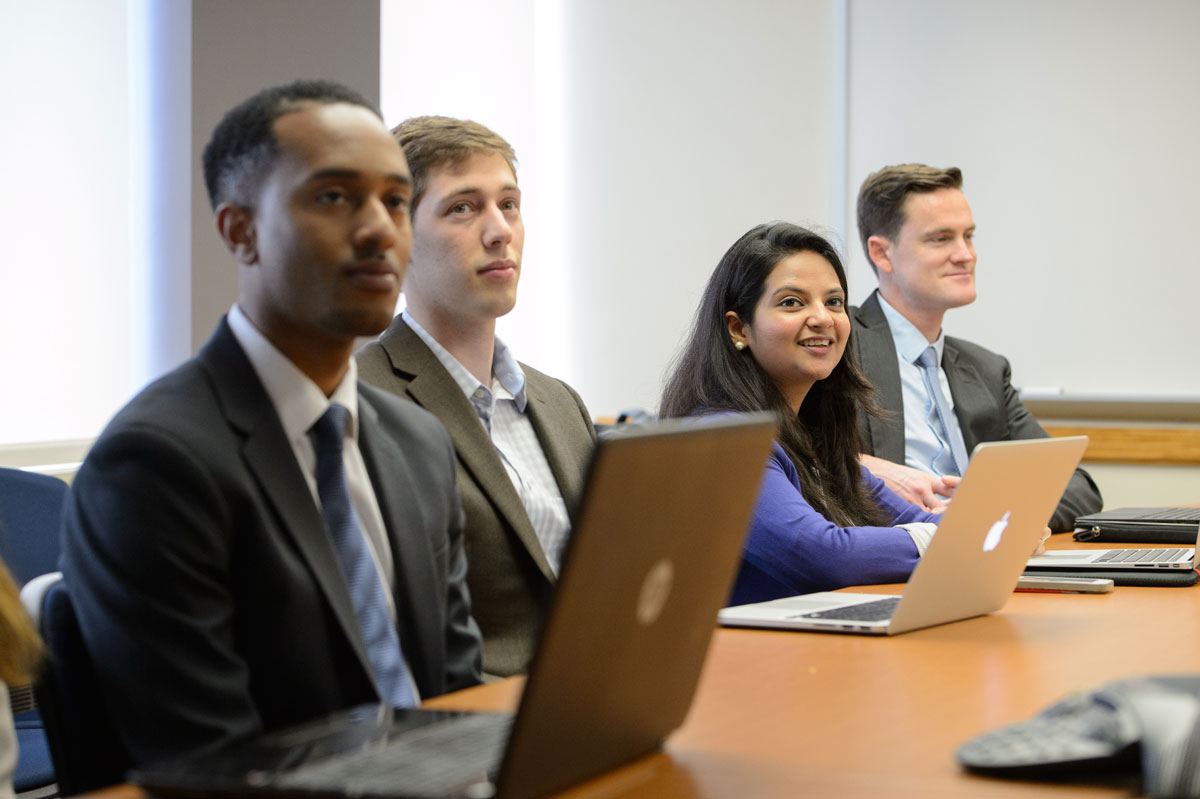 Group of SAIS students at a meeting with laptops